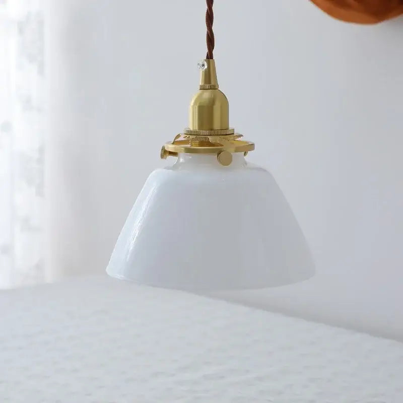 Modern brass and clear glass chandelier pendant light with white translucent glass and twisted brown cord for dining room