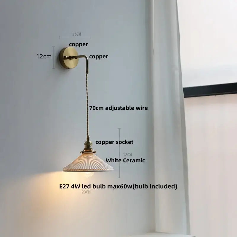 Modern brass wall lamp with clear glass shade and brass-finished copper bracket for decorbites clear glass bedroom sconce