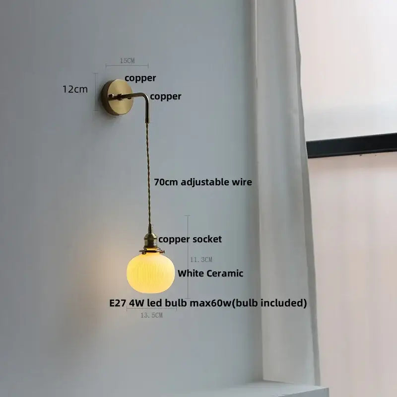 A warm white ceramic wall lamp with copper mount and adjustable wire for decorbites clear glass modern bedroom sconce