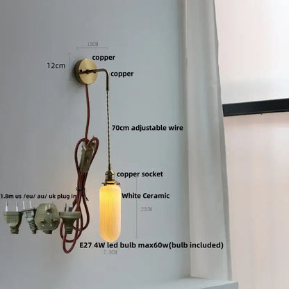 A warm-glowing modern wall lamp with a white ceramic pendant and clear glass shade by decorbites clear glass