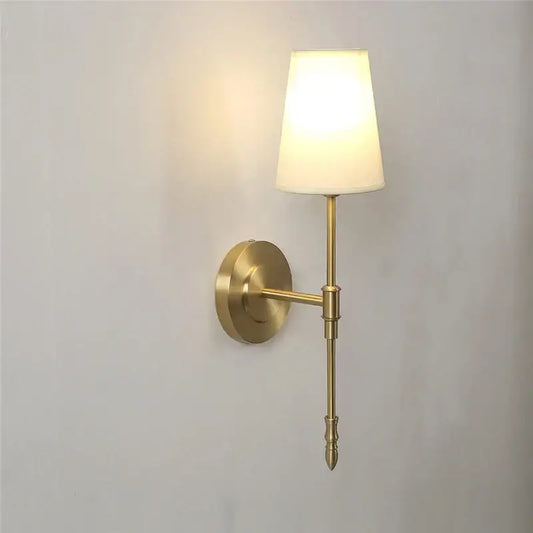 Modern brass and cream fabric led wall lamp with brass finish and cream shade ideal for bedroom wall lamps