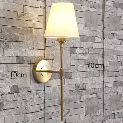Modern brass and cream fabric led wall lamp with tapered off-white shade ideal for bedroom wall lamps lighting