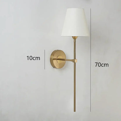 Modern brass led wall lamp with cream fabric shade for bedroom featuring a gold finish and LED lighting