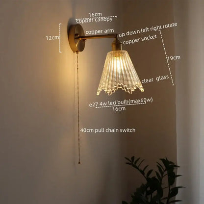 Modern brass and crystal led wall lamp with copper sconce and clear glass shade featuring vertical ridges and scalloped edges