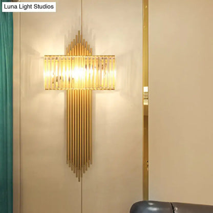 Modern brass and crystal rectangular wall lighting with gold-toned vertical rods and a glass panel emitting warm light