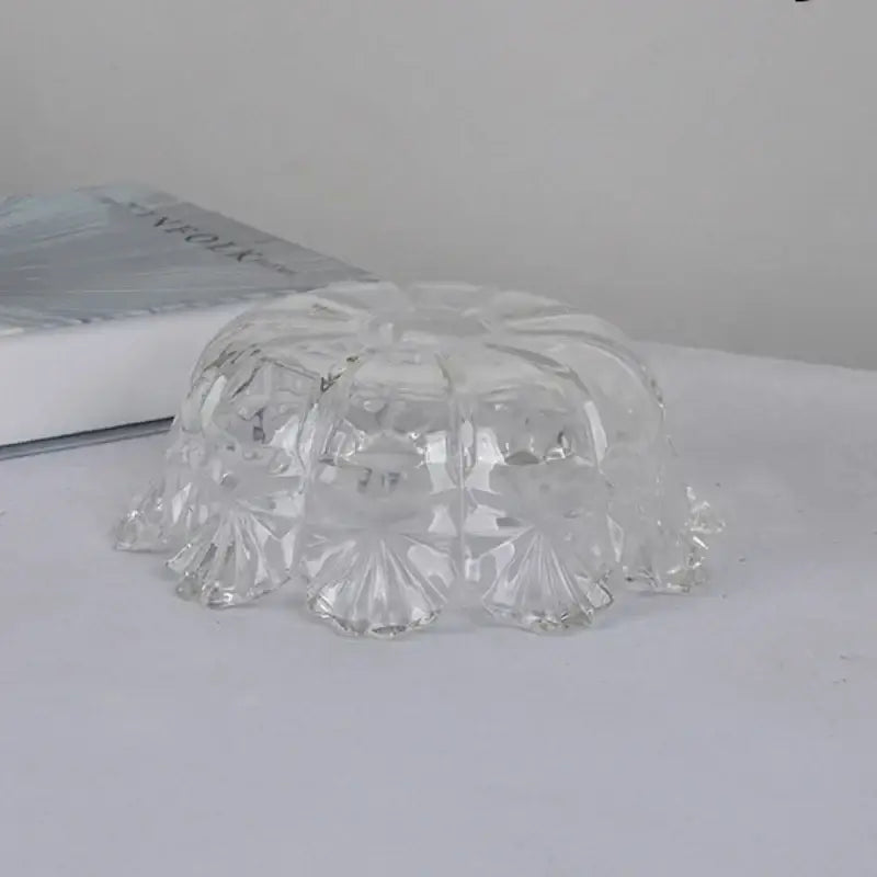 Clear glass bowl with faceted floral patterns and scalloped edge as part of a modern brass led pendant light