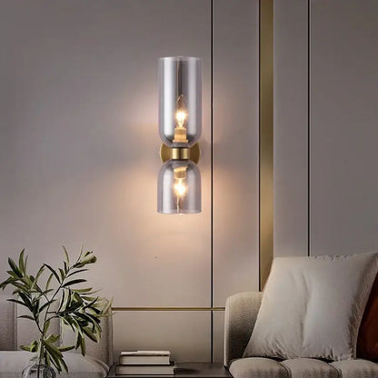 Modern brass wall lamps with decorbites glass ball smoked shades and brass accents for bedroom sconces