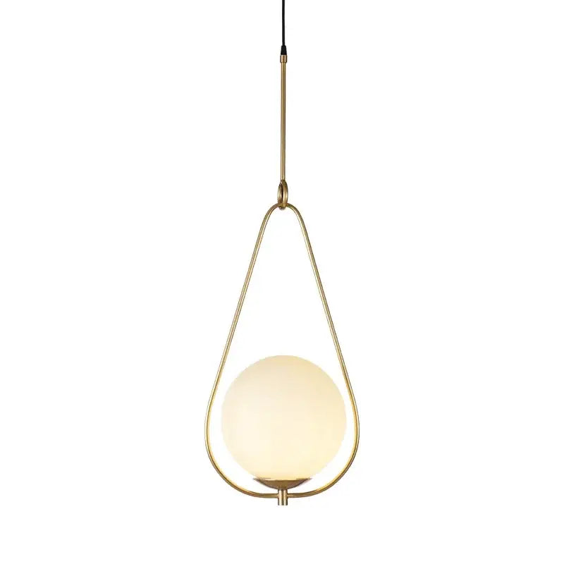 Modern brass and frosted glass ball pendant light with a warm-toned spherical shade for dining room decorbites light fixture