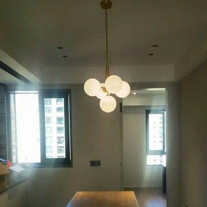 Modern brass and frosted glass chandelier with five globe bulbs for elegant glass chandelier living room decorbites decor