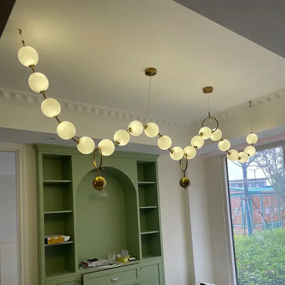 Modern brass and glass ball pendant light featuring frosted glass spheres and gold-toned fixtures for dining room decorbites glass ball chandelier