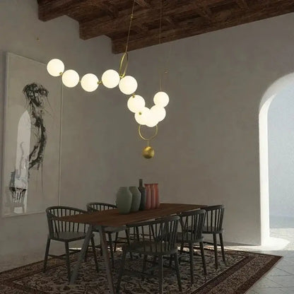 Modern brass and glass ball pendant light with white spherical glass balls and gold-toned metal rings for dining room decorbites glass ball chandelier
