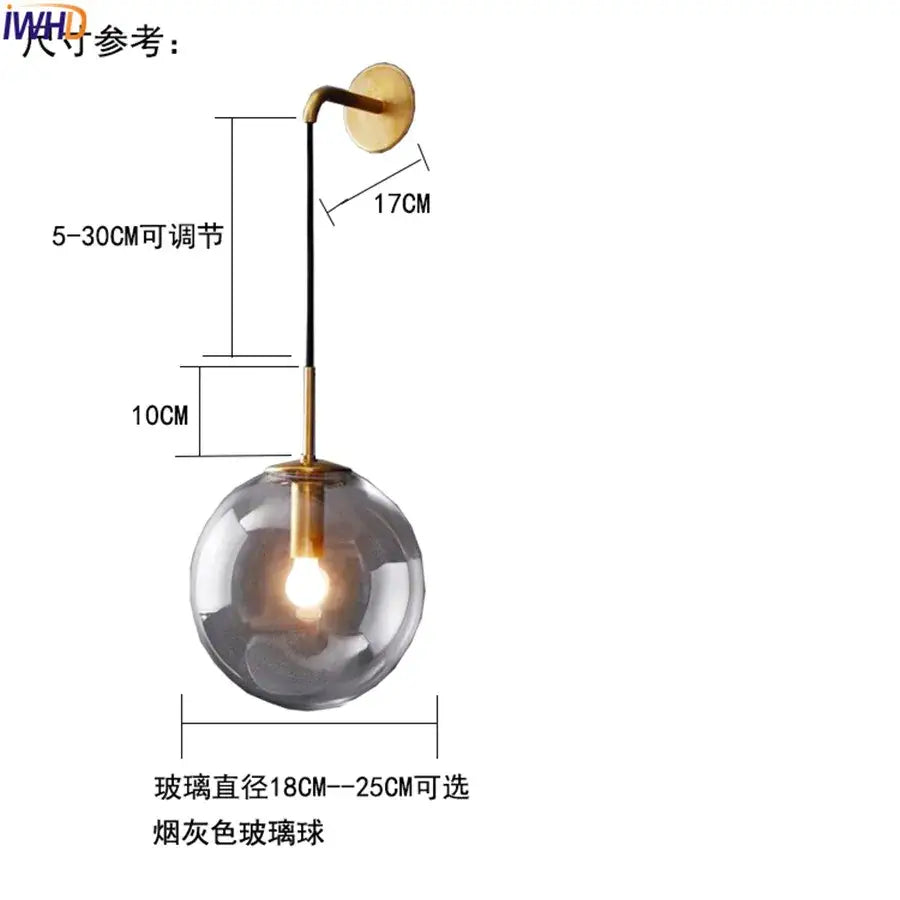Modern brass and glass ball wall lamp with smoked glass globe and adjustable black cord for elegant bathroom lighting decorbites glass ball