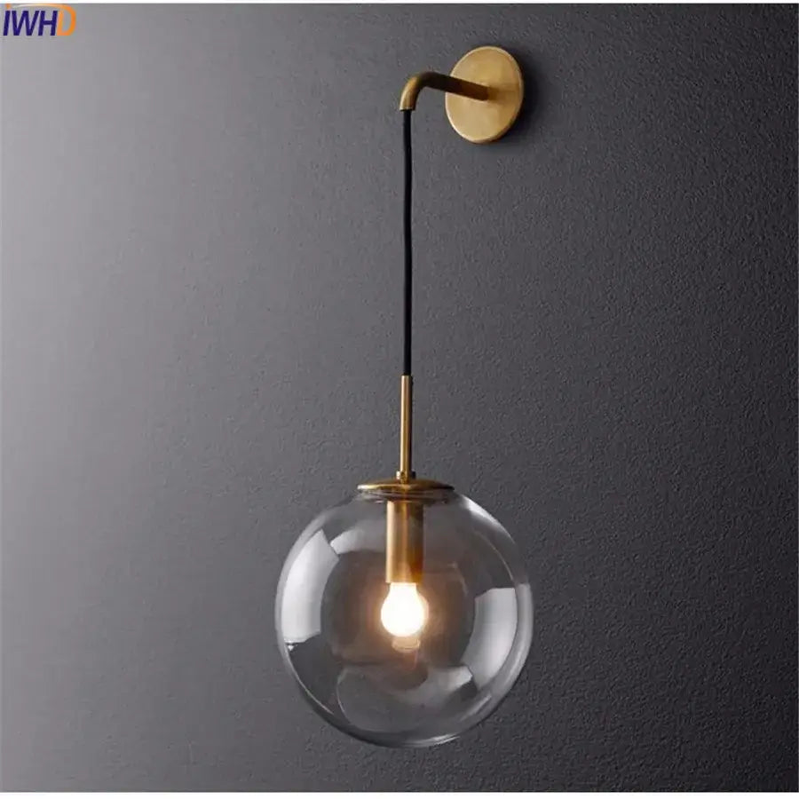 Modern brass and glass ball wall lamp with spherical glass ball and black cord for stylish bathroom decorbites glass ball