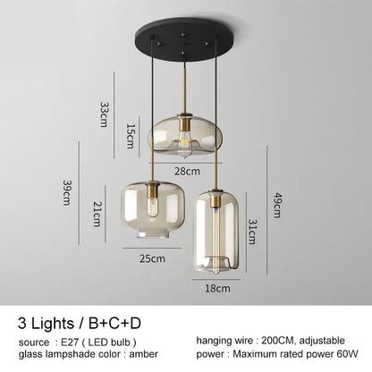 Modern brass and glass pendant lights with amber-tinted glass pendant shades for kitchen and dining room lighting