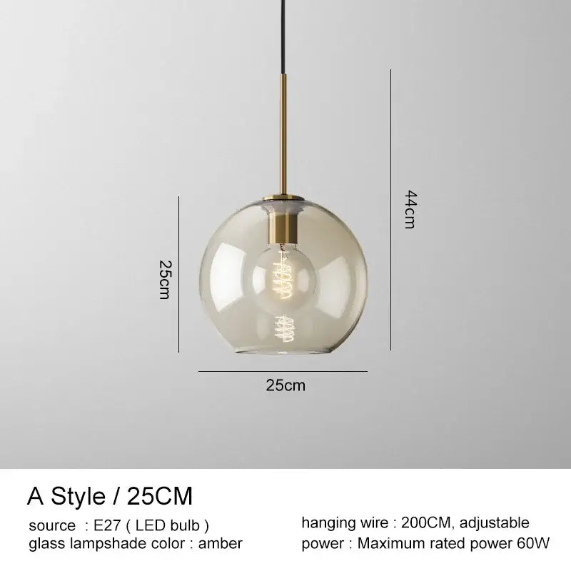 Modern brass and glass pendant lights featuring a spherical amber glass pendant lampshade for kitchen dining room use