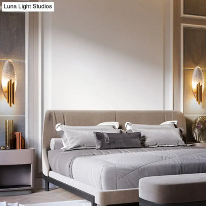 Modern brass and glass wall light bedroom sconce with e12 e14 base and beige upholstered bed with dark metal legs