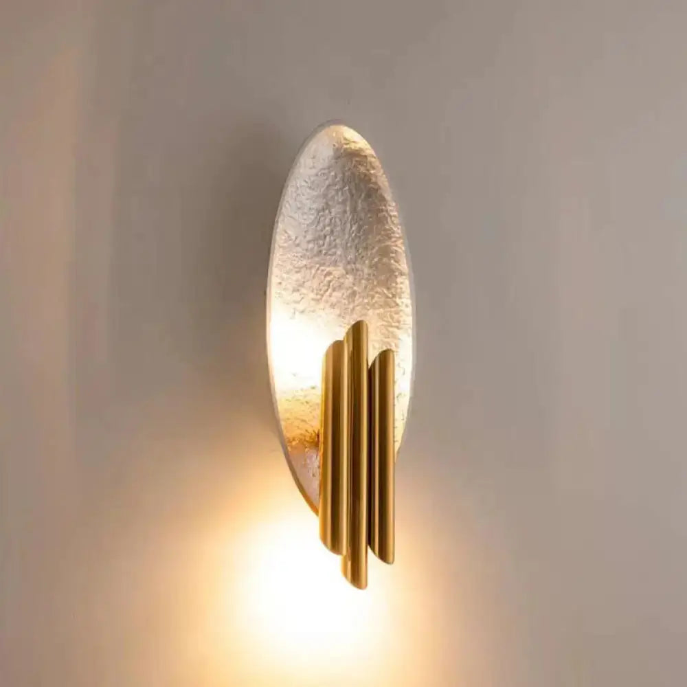 Modern brass and glass wall light with textured translucent oval shade and three vertical tubes for e12 e14 base bulbs