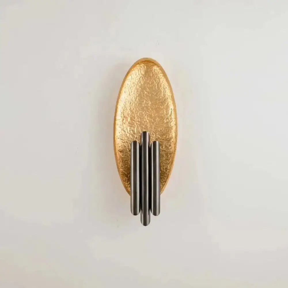 Modern brass and glass wall light bedroom sconce with gold-toned textured oval and four vertical matte black rods e12 e14 base
