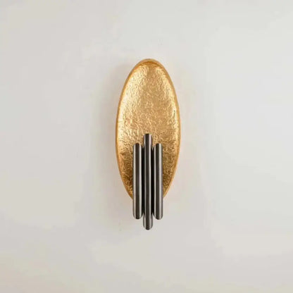 Modern brass and glass wall light bedroom sconce with gold-toned textured oval and four vertical matte black rods e12 e14 base
