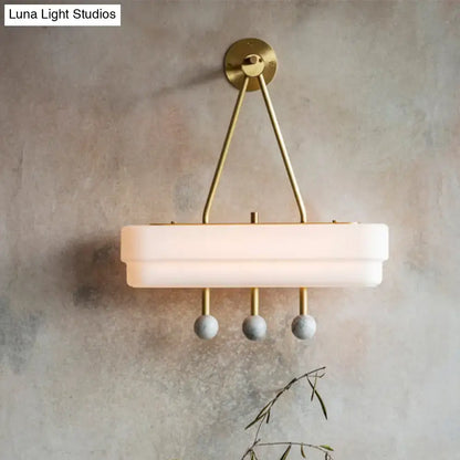 Modern brass and gray sconce light fixture wall lamp with brushed brass frame and frosted glass for dining room wall