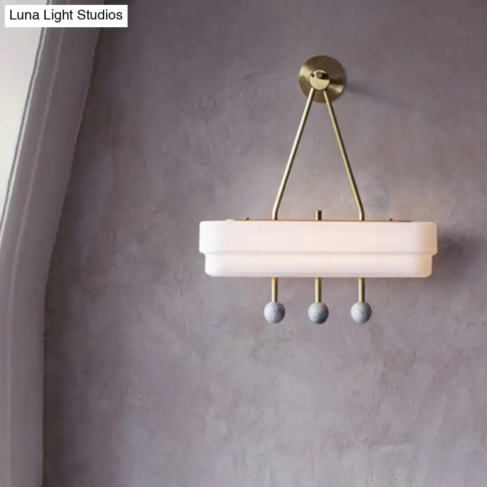 Modern brass and gray sconce light fixture with white frosted glass shade and spherical pendants for dining room wall lamp