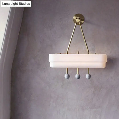 Modern brass and gray sconce light fixture with white frosted glass shade and spherical pendants for dining room wall lamp