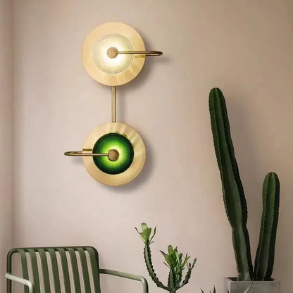 Modern brass and green glass metal wall art lamp with gold-toned sconce and dual circular shades for living room
