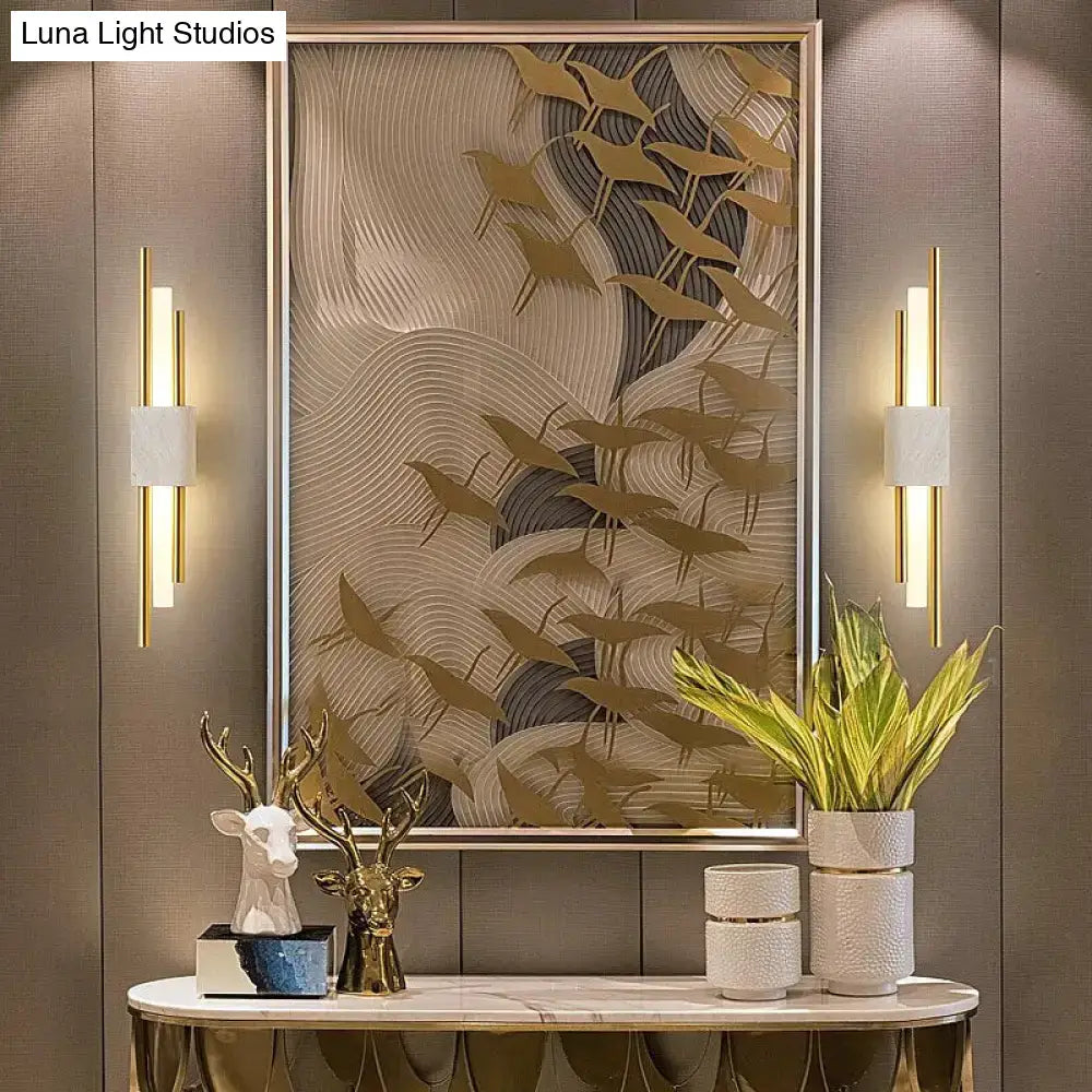 Modern brass and green marble led wall lamp featuring gold-toned sculptural birds on a textured wave background