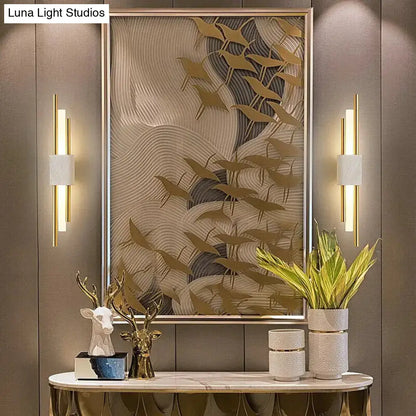 Modern brass and green marble led wall lamp featuring gold-toned sculptural birds on a textured wave background