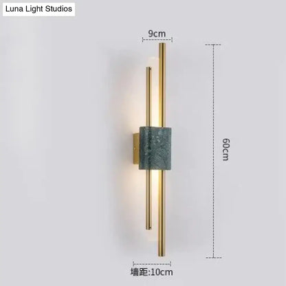 Modern brass and green marble led wall lamp with slender gold-toned rods and dark green marble accent for living room