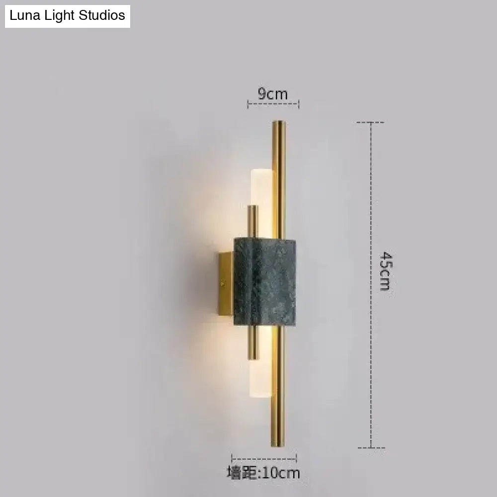 Modern brass and green marble led wall lamp featuring a sleek gold frame and frosted glass diffuser for living room