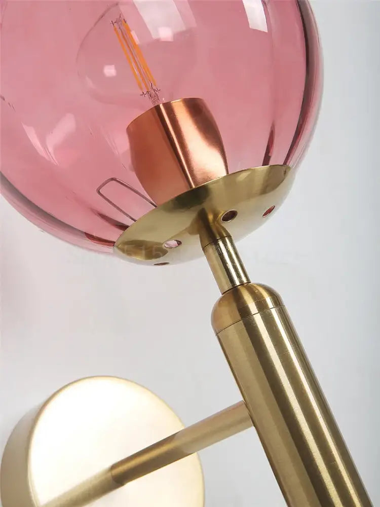 Modern brass and pink glass wall sconce with translucent globe and polished hardware for bedroom decorbites blue glass inspired