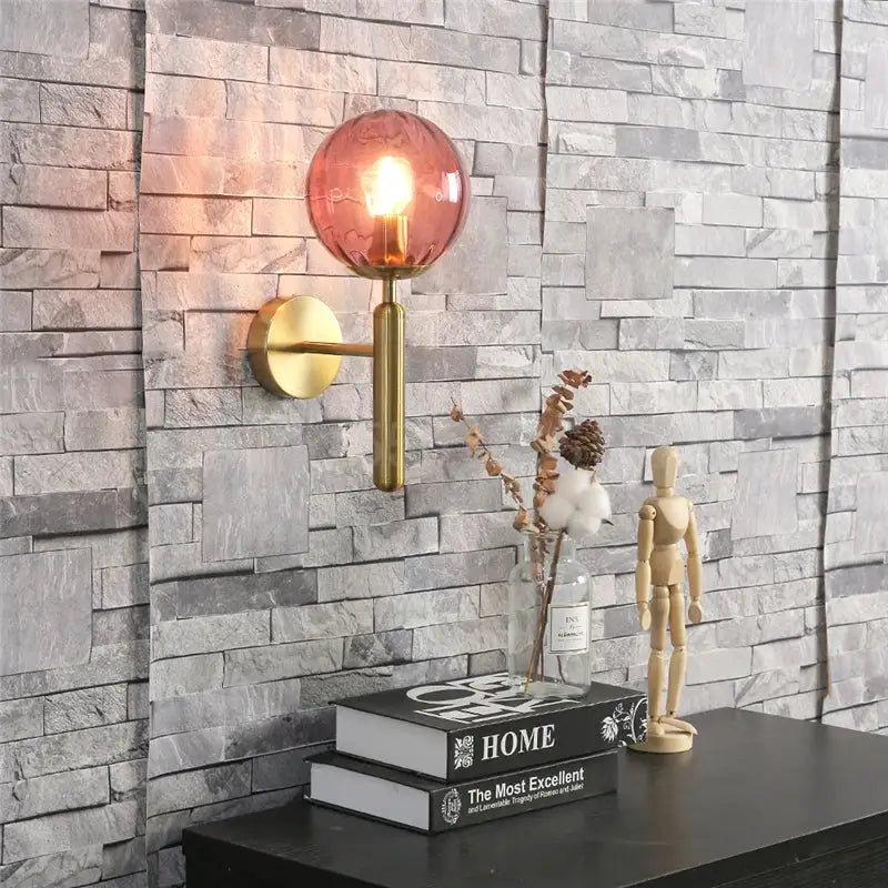 Modern brass and amber glass wall sconce with polished brass arm and circular backplate for bedroom decorbites blue glass