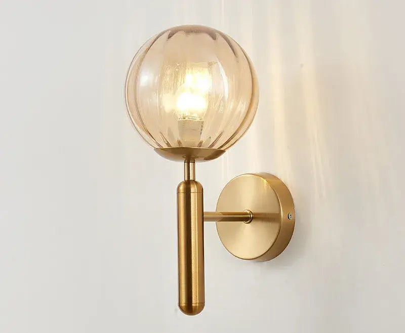 Modern brass wall sconce with ribbed amber glass globe suitable for bedroom decor featuring decorbites blue glass balls