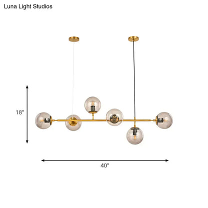 Gold-toned DecorBites™ modern bubble chandelier lighting with six smoke gray glass globe bulbs for kitchen or dining room