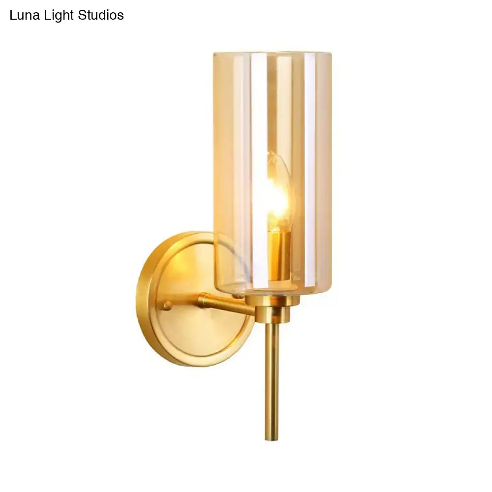 Modern brass and smoked glass wall sconce with gold-toned finish and e26 bulb base for bedroom lighting