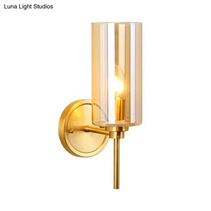 Modern brass and smoked glass wall sconce with gold-toned finish and e26 bulb base for bedroom lighting
