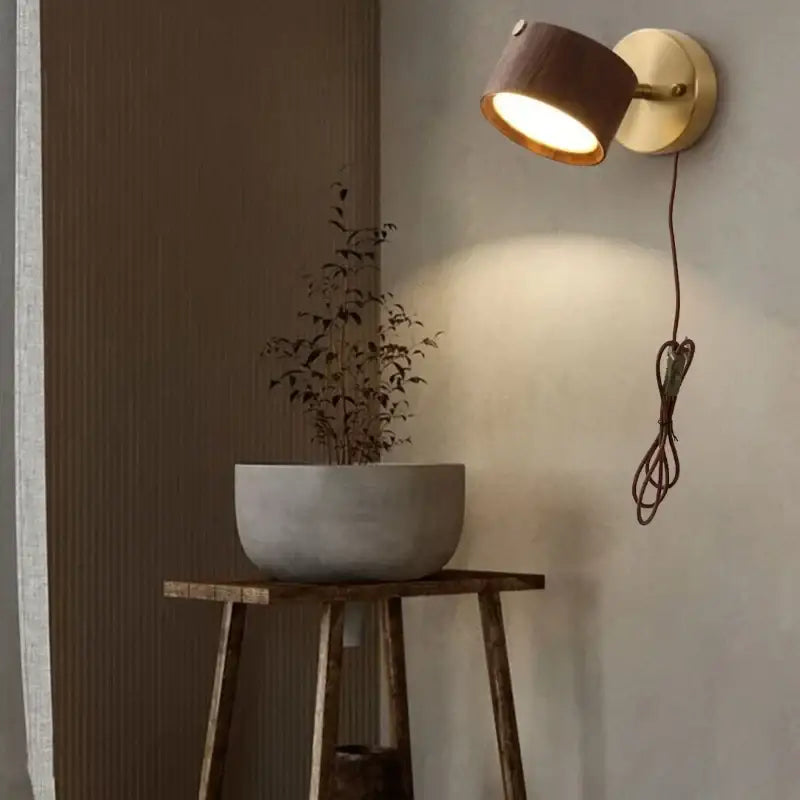 Modern brass and walnut led wall sconce with warm-toned wooden and brass spotlight for bedroom lighting