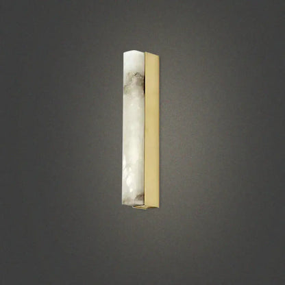 A modern brass and white onyx wall lighting sconce with translucent onyx and polished brass for living room use