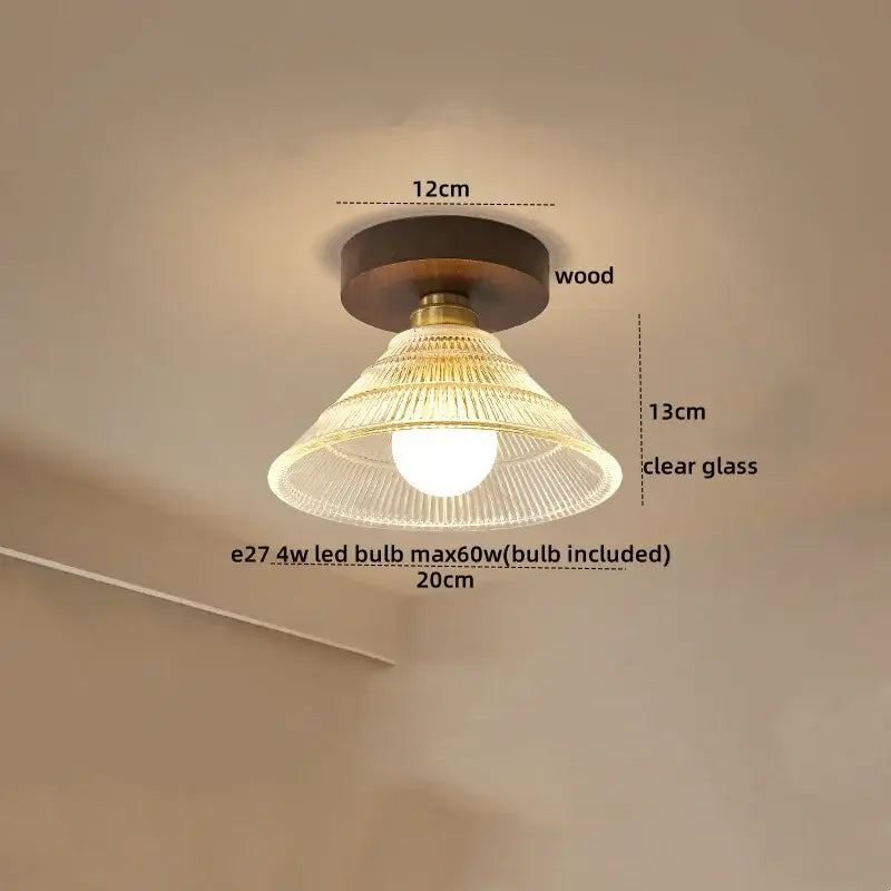 A vintage-style ceiling light with brass accents, dark wood base, and clear ribbed glass shade for decorbites led ceiling use