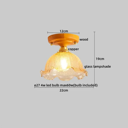 A warm-toned textured glass lampshade with scalloped edge on a wood and brass decorbites led ceiling light