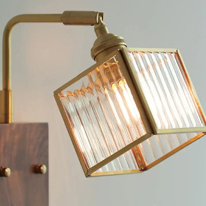 Modern brass and wood led wall lights with a brass finish and square ribbed glass shade for bedroom use