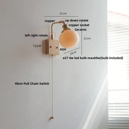 Modern copper-finished wall light fixture with ceramic globe shade and adjustable pull chain for bedroom use