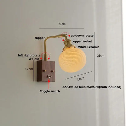 Modern brass and wood wall light fixture with a brass copper arm, walnut-finished plate, toggle switch, and white ceramic globe shade