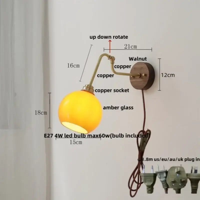 Modern brass and wood wall sconce with warm amber led globe lamp copper arm and walnut decorbites copper glass mount