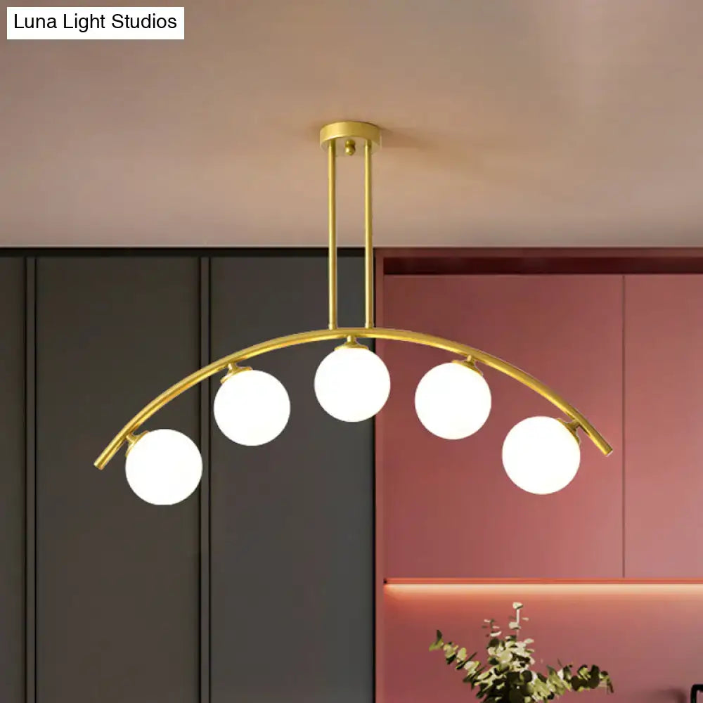 Decorbites modern glass orb island pendant light with five frosted glass bulbs and brass arch arm in gold tone