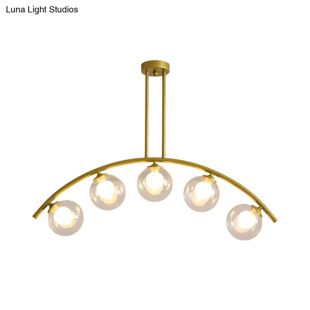 Decorbites modern glass orb island pendant light with five clear bulbs and brass arch arm in gold tone for dining room