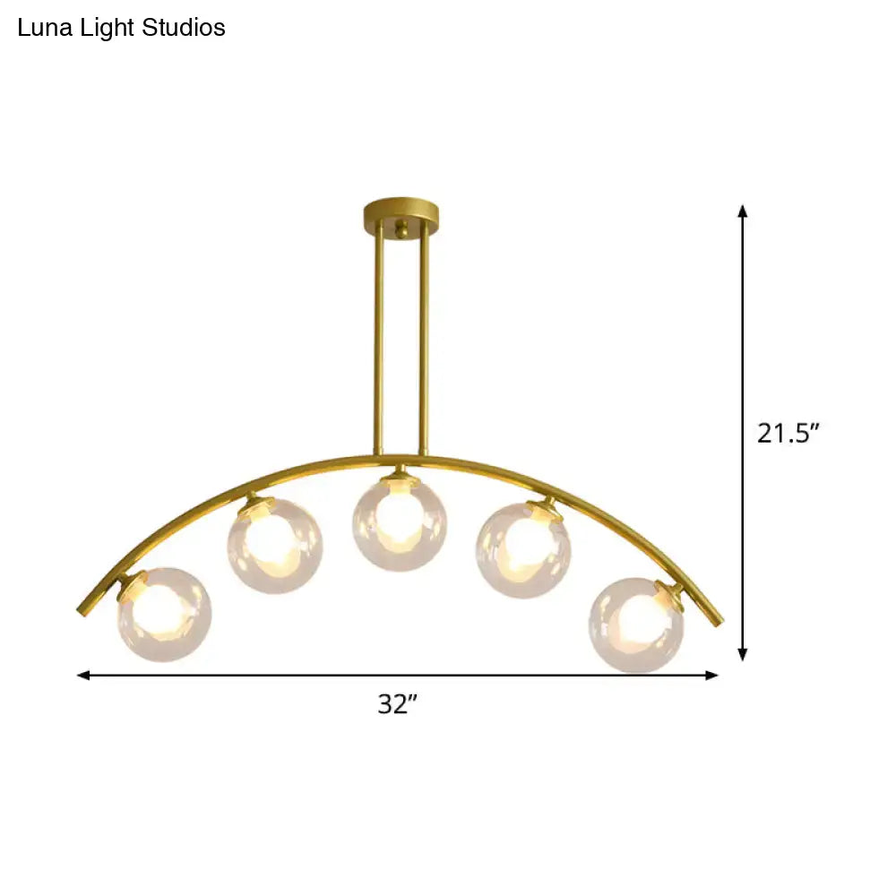 Decorbites modern glass orb island pendant light with five white glass bulbs and brass arch arm for dining room