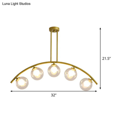 Decorbites modern glass orb island pendant light with five white glass bulbs and brass arch arm for dining room