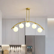 Decorbites™ modern pendant light with five white frosted glass orbs and a gold-toned brass arch arm design
